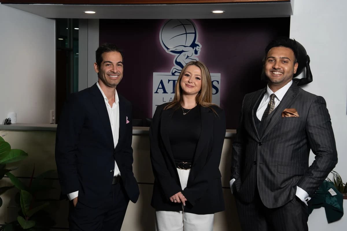 Atlas colleagues in front of the office logo